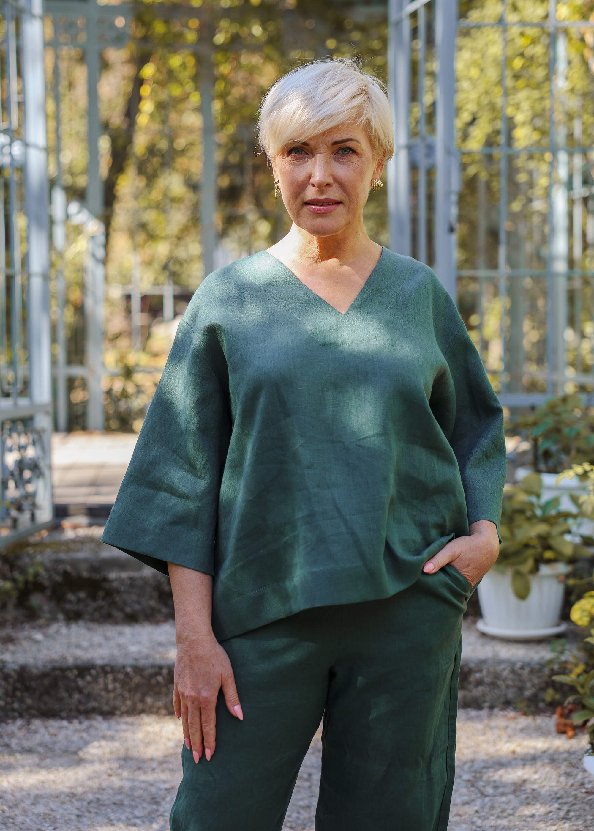 a woman standing in front of some plants