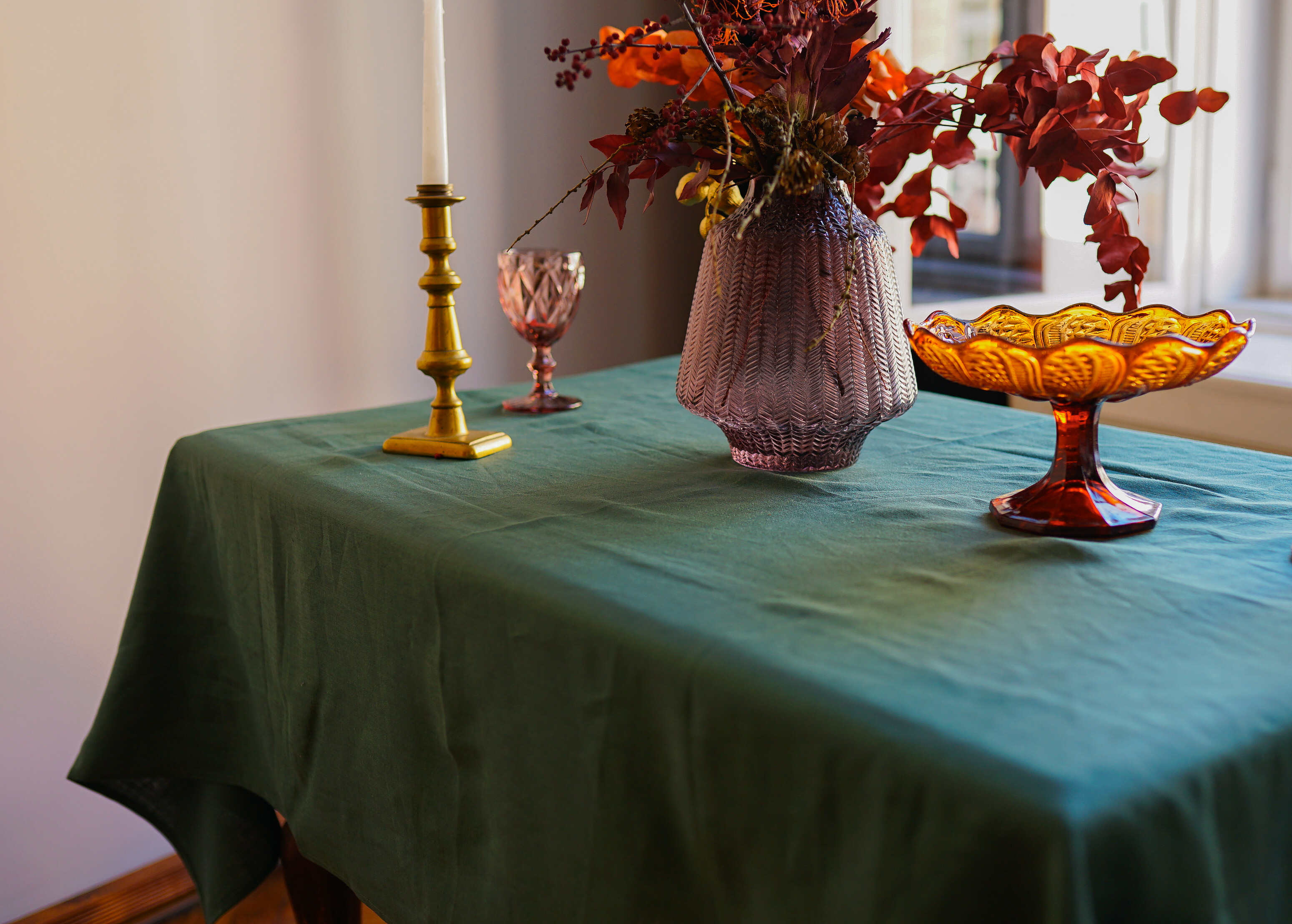 a table topped with a vase filled with flowers