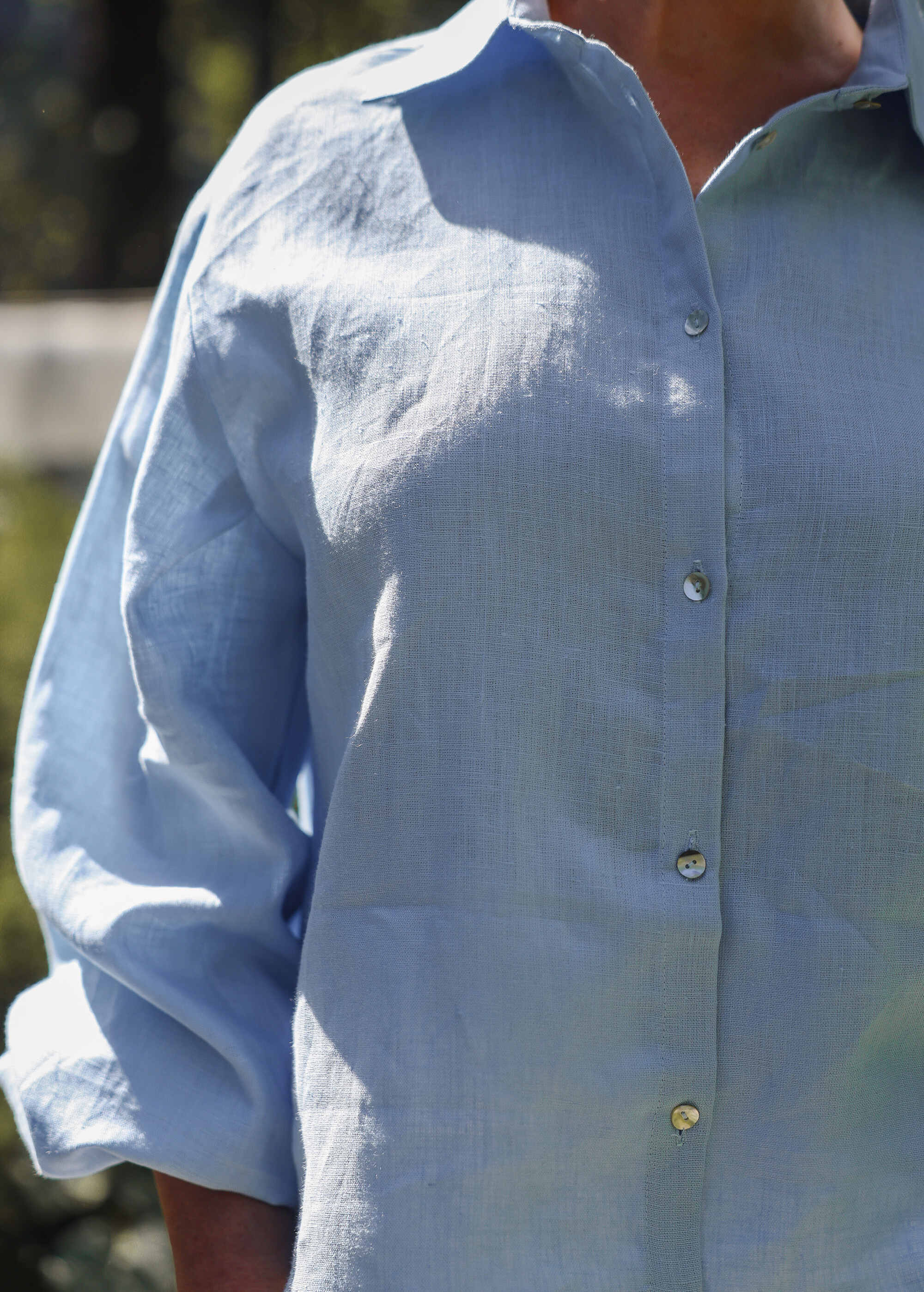 a man wearing a blue shirt and sunglasses