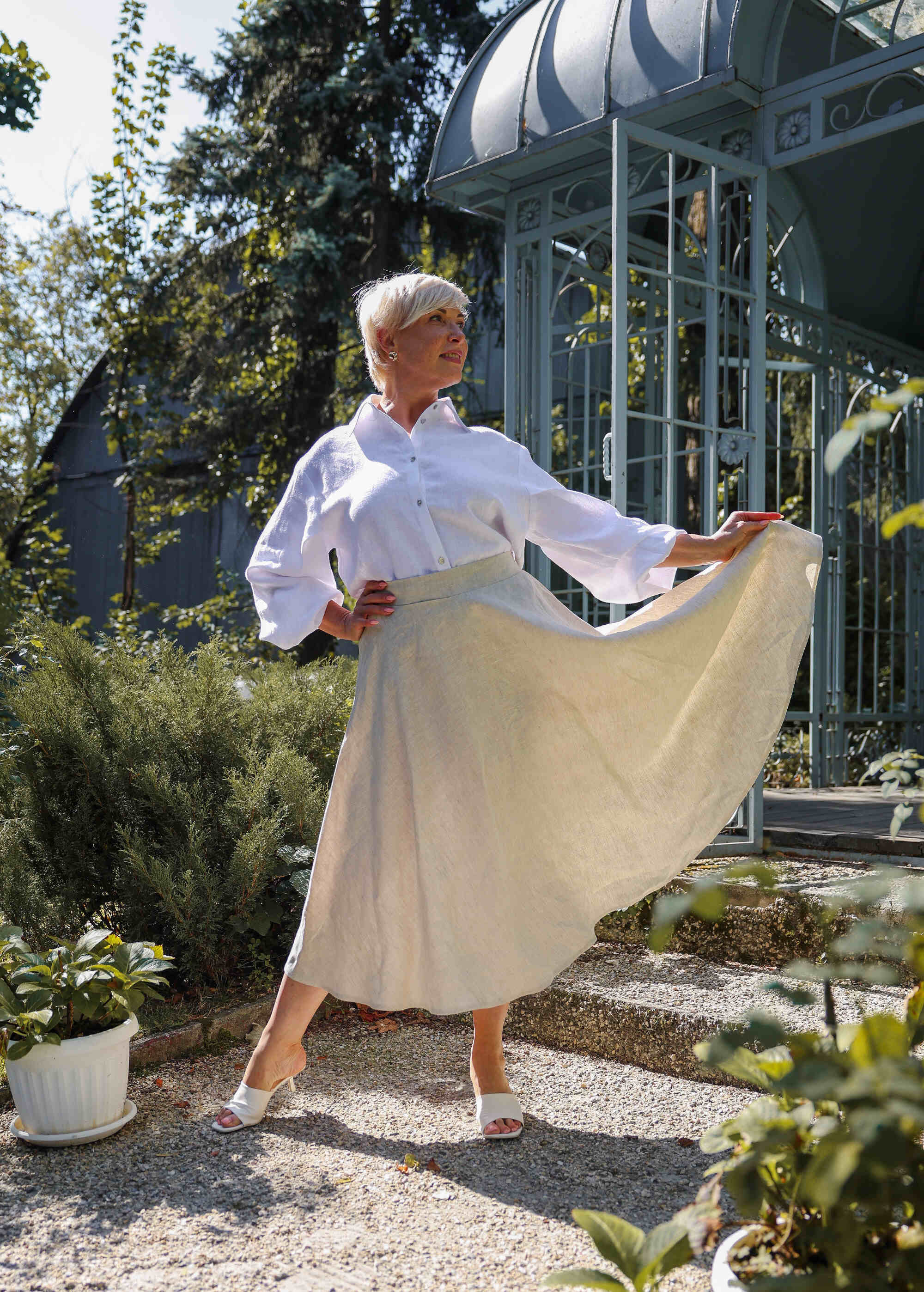 a woman in a white shirt and a white skirt