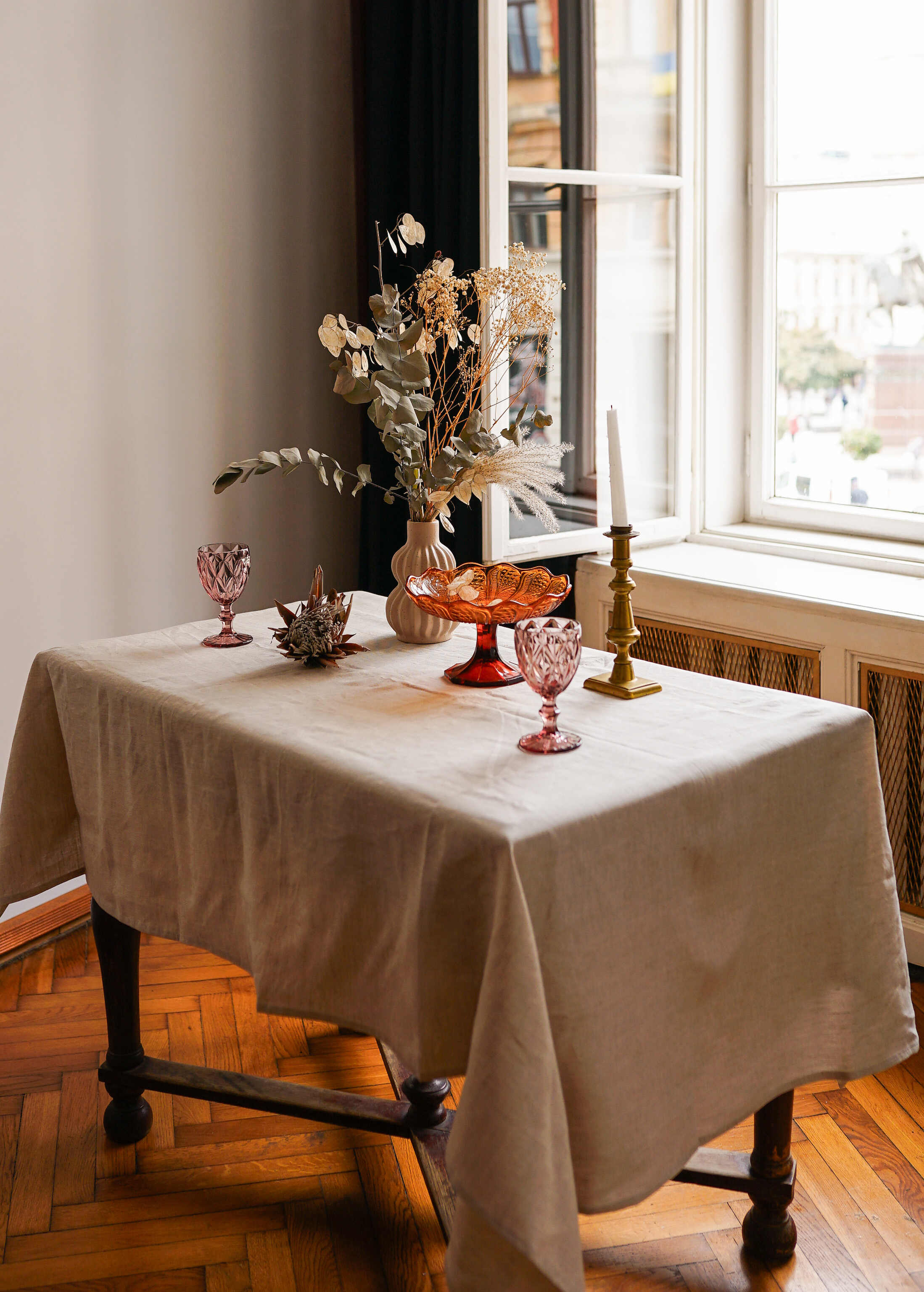 a table with a cloth on it and a vase with flowers on it