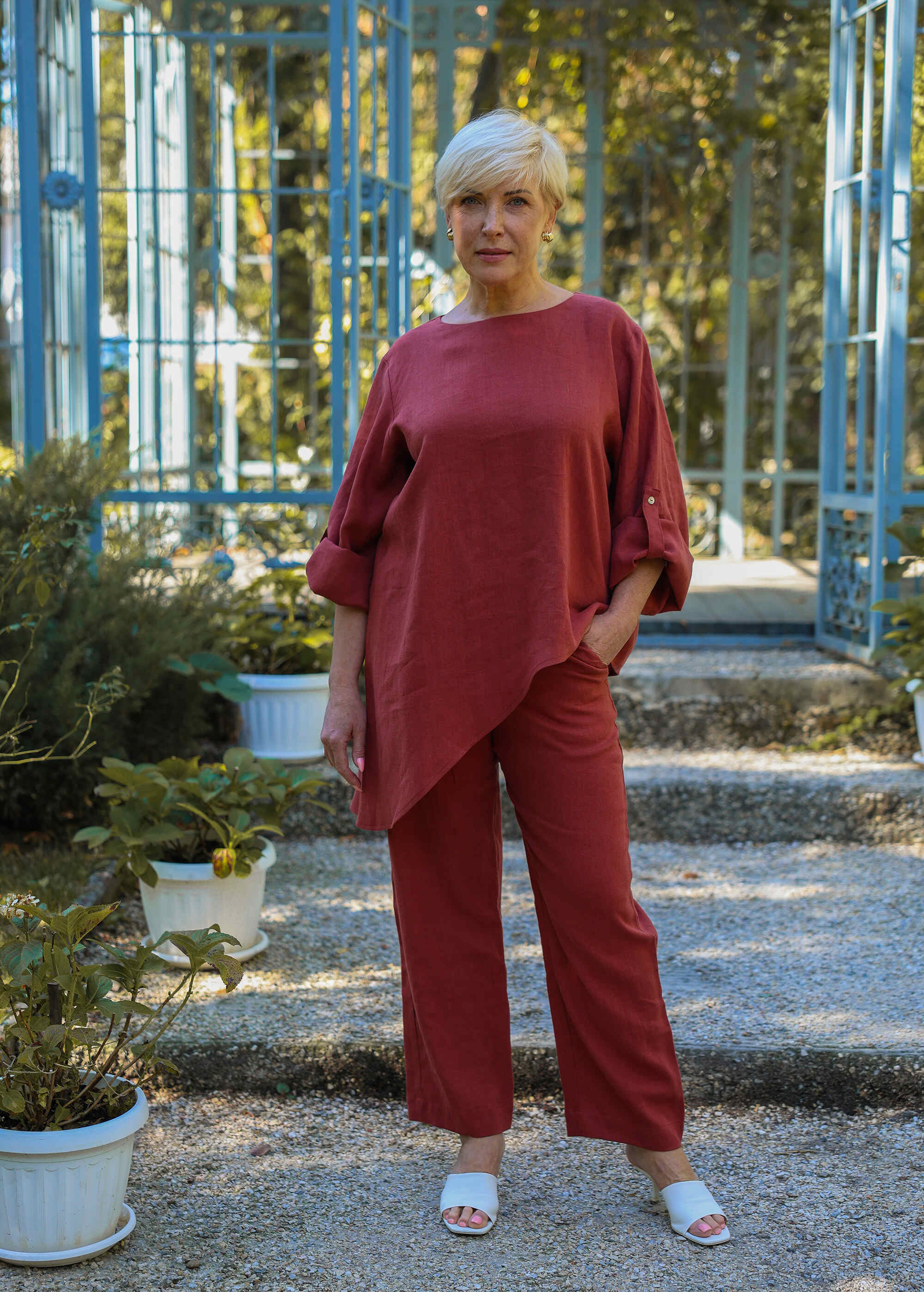 a woman standing in front of some plants