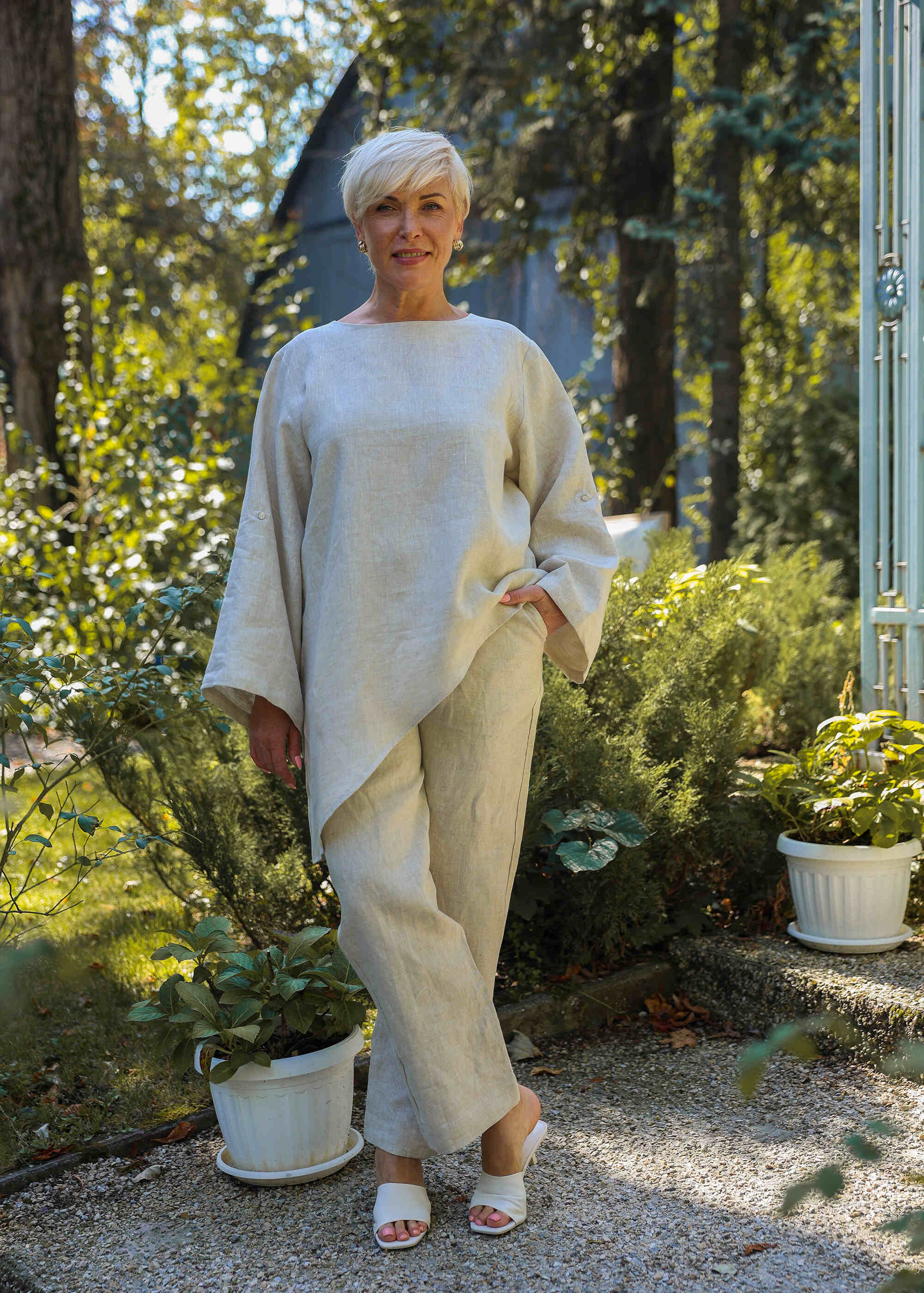 a woman standing in front of some plants